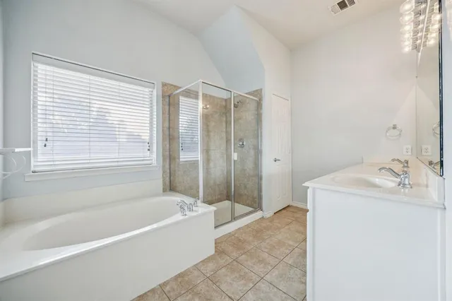 a bathroom with a tub sink and a shower