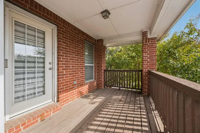 a view of a balcony with wooden floor