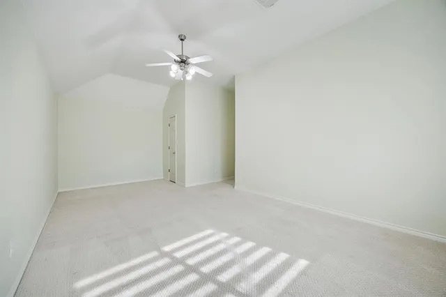 a view of an empty room with a fan
