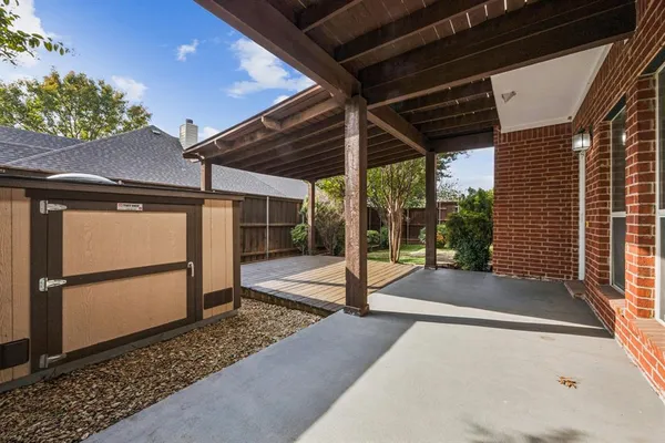 a view of a backyard with small cabin and wooden fence