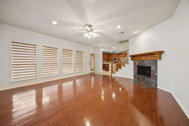 a view of an empty room with a window and fireplace