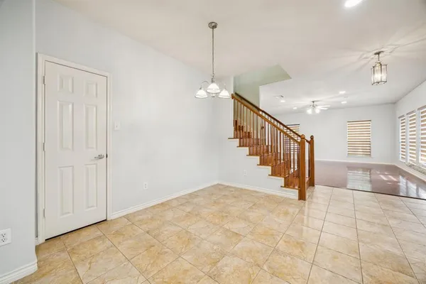 a view of a hallway with windows and stairs