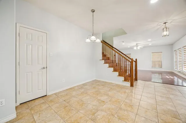 a view of a hallway with windows and stairs