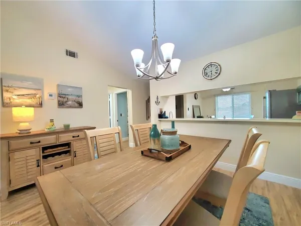 a living room with kitchen island furniture and a chandelier