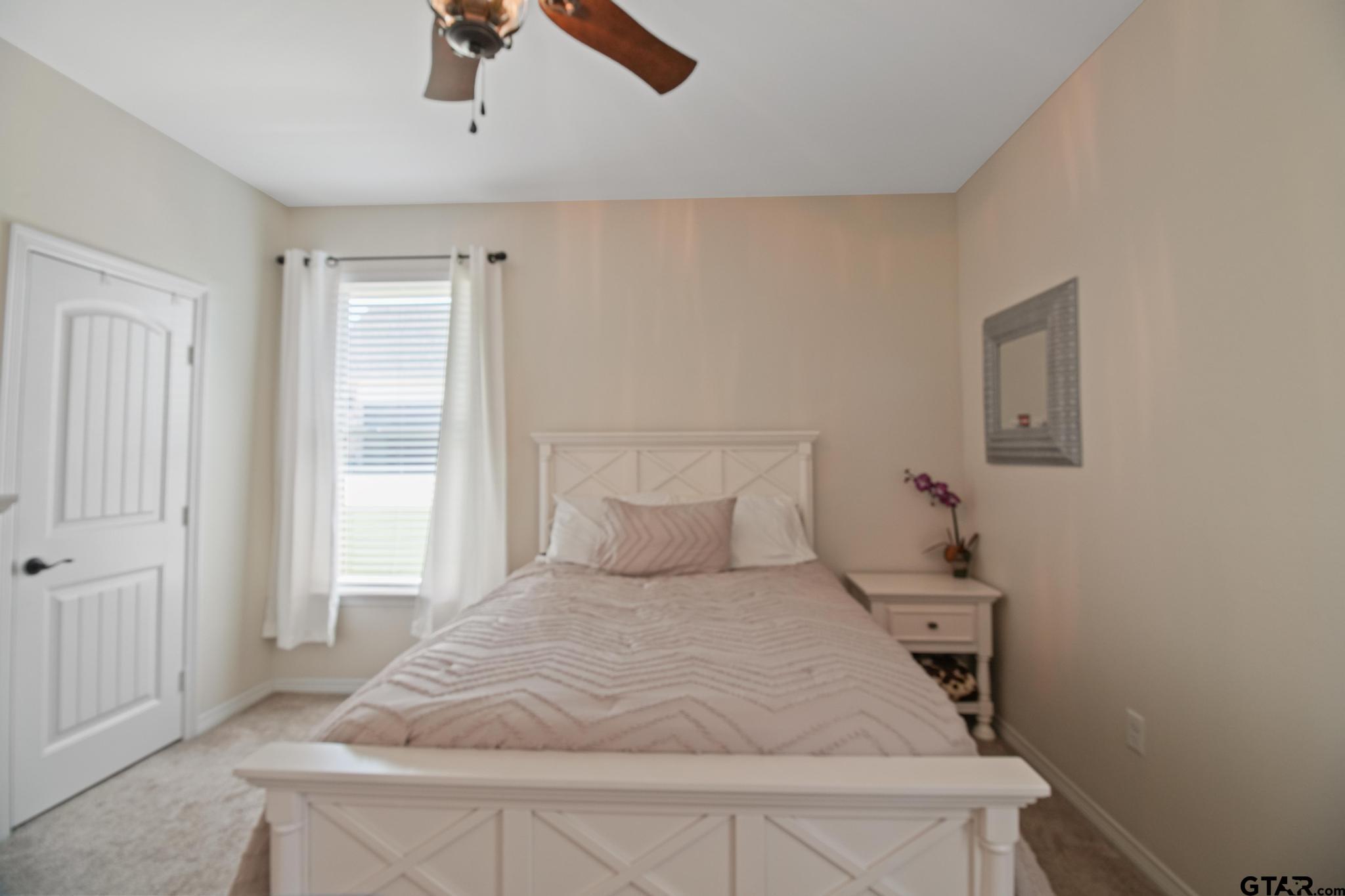 109 Nathan Road Chandler, TX 75758 - Photo 22 of 48 a bedroom with a bed and painting on the wall