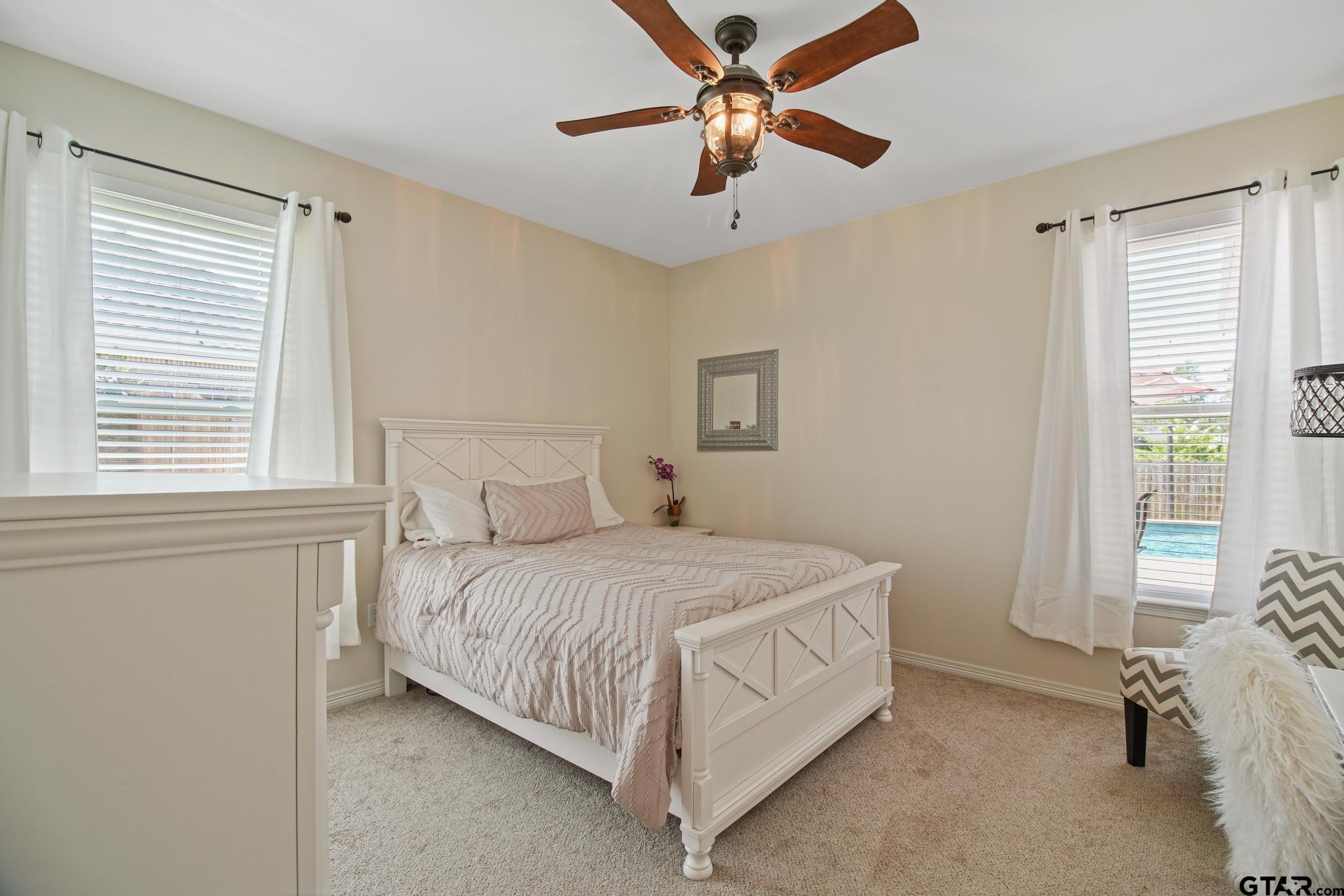 109 Nathan Road Chandler, TX 75758 - Photo 23 of 48 a bedroom with a bed chandelier and a window