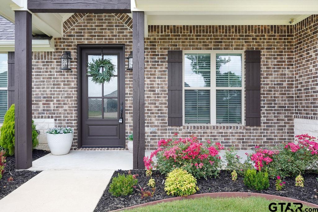 109 Nathan Road Chandler, TX 75758 - Photo 47 of 48 a front view of a house with a flower garden