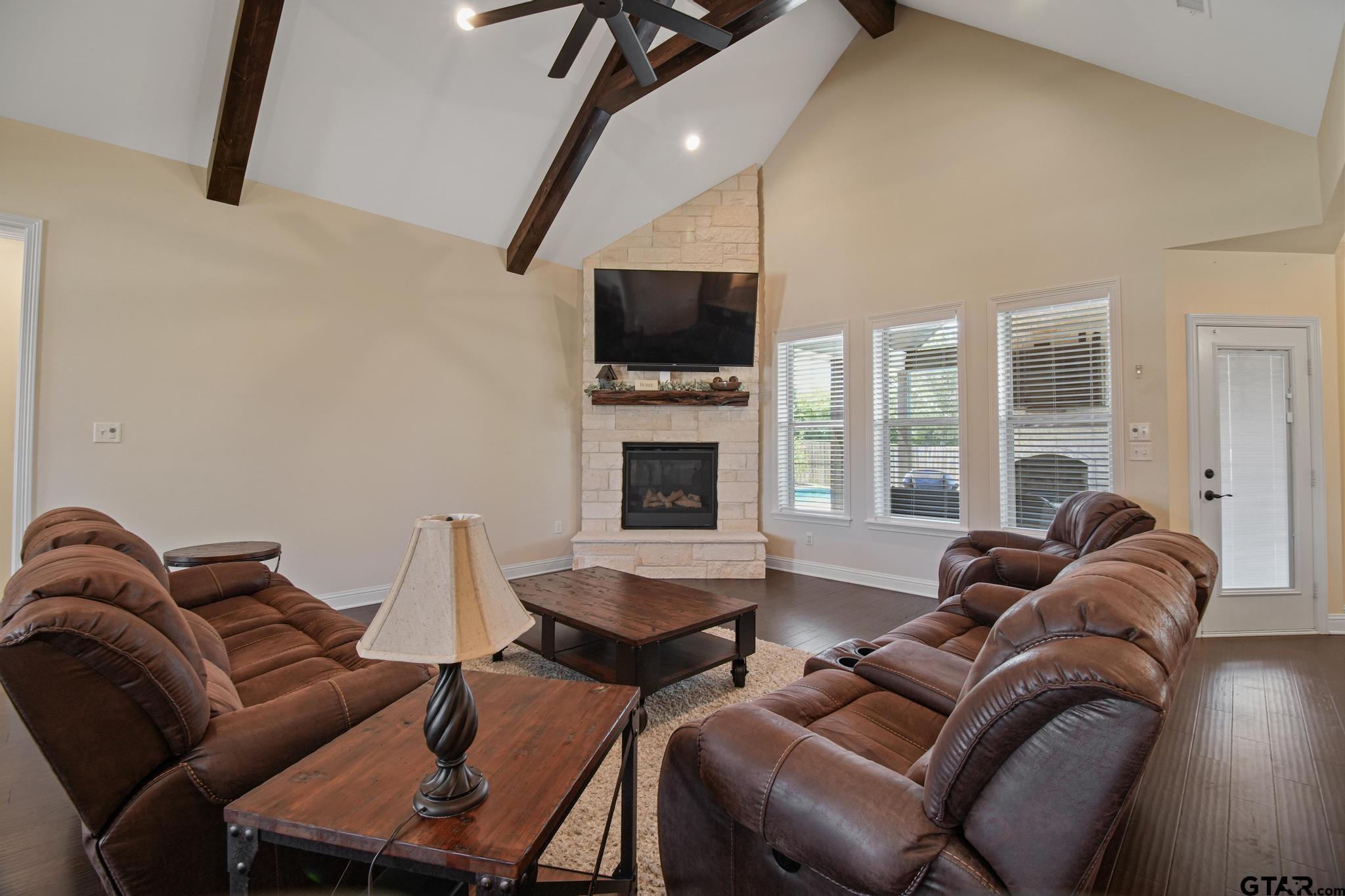 109 Nathan Road Chandler, TX 75758 - Photo 7 of 48 a living room with furniture a flat screen tv and a fireplace