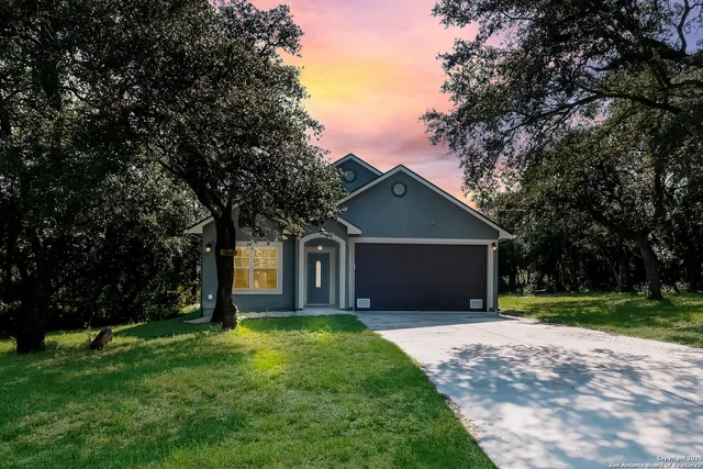 a front view of house with a garden