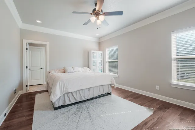 a spacious bedroom with a bed and a window