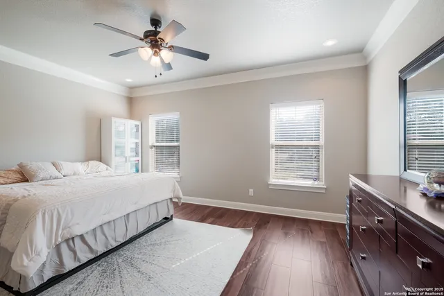 a bedroom with a large bed a chandelier and a window