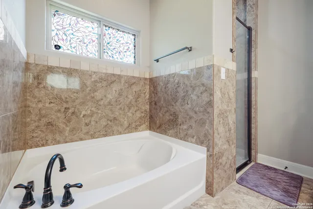 a bathroom with a bathtub and shower