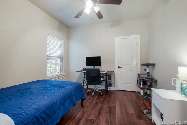 a bedroom with a bed and wooden floor