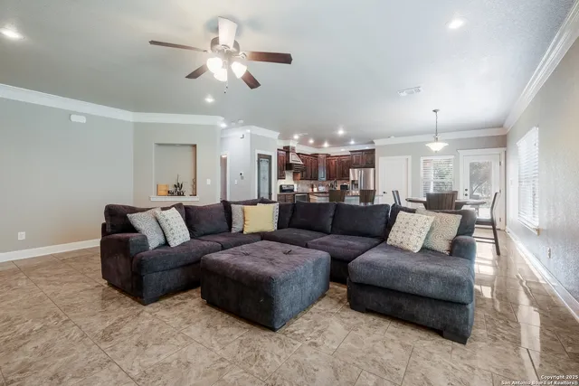 a living room with furniture and a chandelier