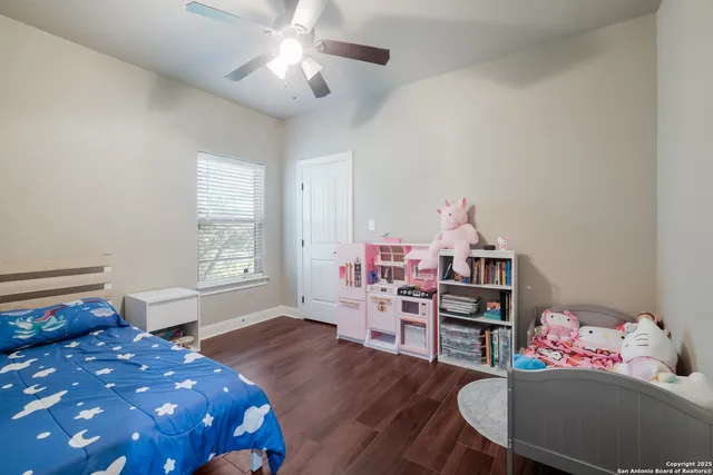 a bedroom with furniture and a wooden floor