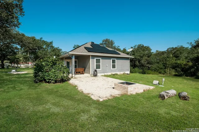 a view of a house with backyard and garden