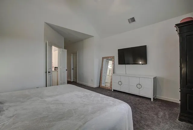 a bedroom with a bed and a lamp