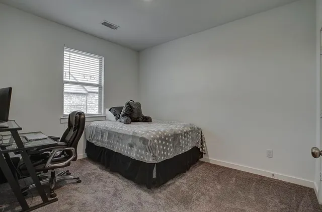 a view of a room that has a bed in it