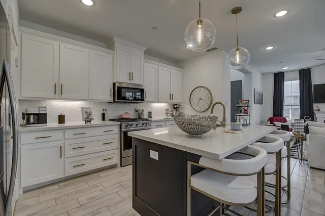 a kitchen with a sink stove and microwave