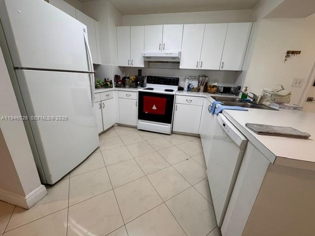 104 Southwest 9th Street, Unit 1403 Miami, FL 33130 - Photo 3 of 11 a kitchen with a refrigerator sink stove and cabinets