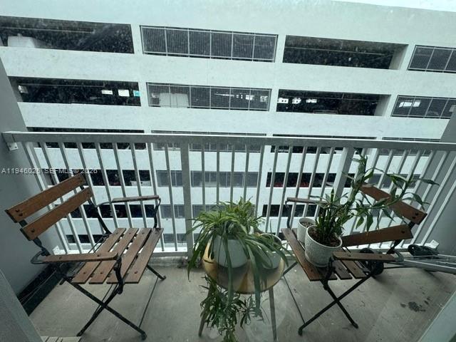 104 Southwest 9th Street, Unit 1403 Miami, FL 33130 - Photo 8 of 11 a view of a chairs and table in a balcony