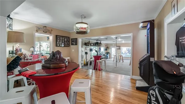 a living room filled with furniture and chandelier