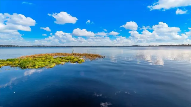 a backyard of a house with barbeque oven table and chairs