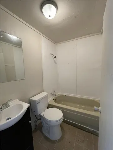 a bathroom with a toilet a sink and bathtub