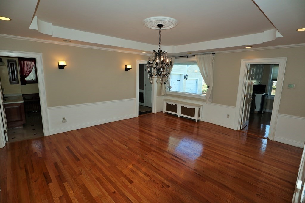 38 Pleasant Street Whitman, MA 02382 - Photo 11 of 21 a view of a livingroom with wooden floor and a ceiling fan
