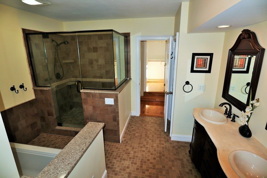 38 Pleasant Street Whitman, MA 02382 - Photo 12 of 21 a bathroom with a sink a mirror and shower