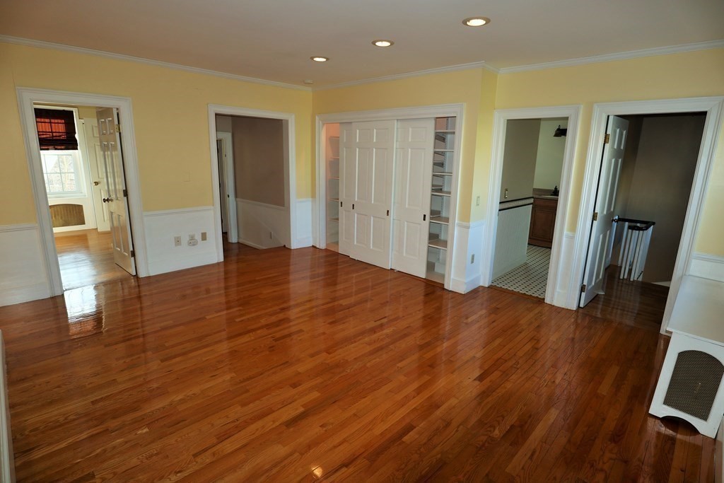 38 Pleasant Street Whitman, MA 02382 - Photo 13 of 21 a view of an empty room with wooden floor and a bathroom