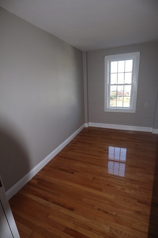 38 Pleasant Street Whitman, MA 02382 - Photo 15 of 21 wooden floor in an empty room with a window
