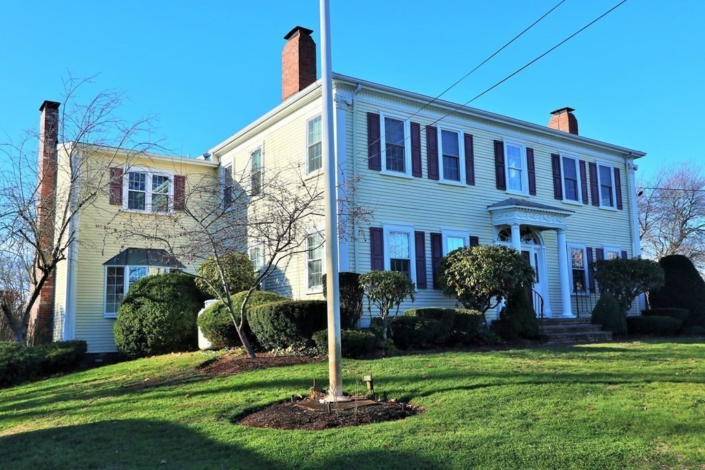 38 Pleasant Street Whitman, MA 02382 - Photo 2 of 21 a front view of a house with garden and trees