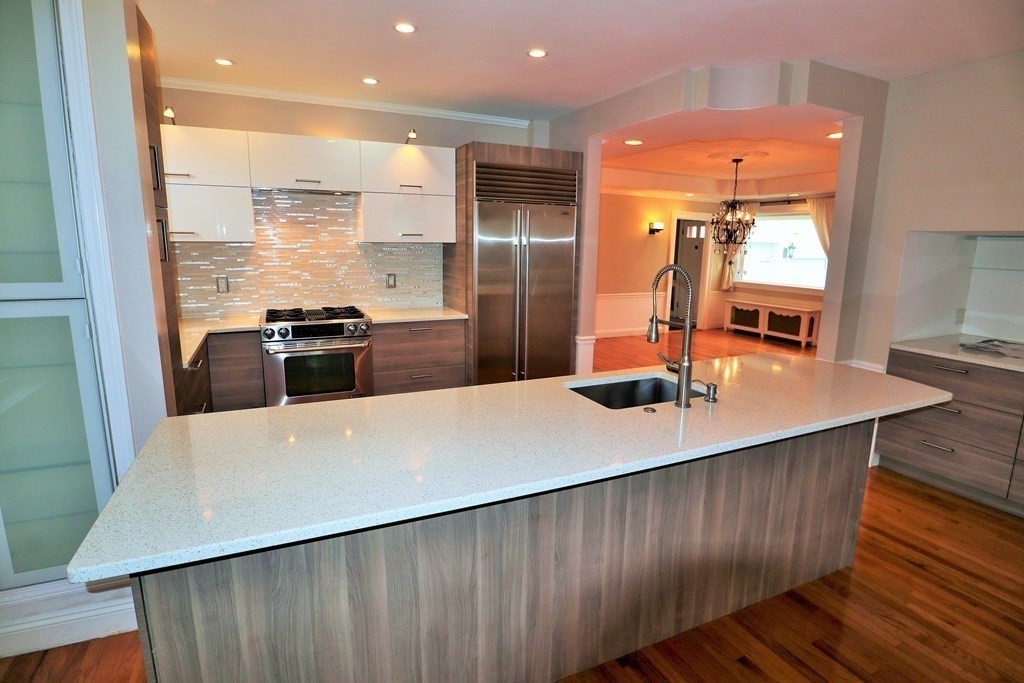 38 Pleasant Street Whitman, MA 02382 - Photo 6 of 21 a large kitchen with stainless steel appliances a large counter top a stove a sink and a refrigerator
