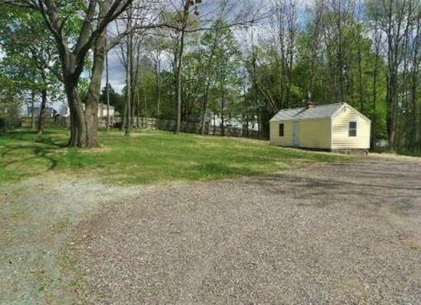 38 Pleasant Street Whitman, MA 02382 - Photo 7 of 21 a view of a house with a yard and large trees