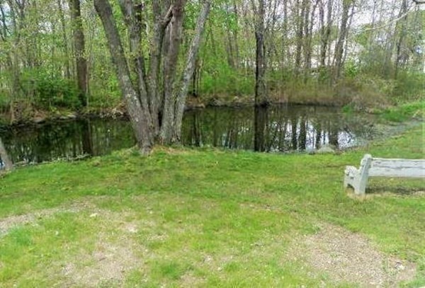 38 Pleasant Street Whitman, MA 02382 - Photo 8 of 21 a backyard of a house with lots of green space and lake view in back