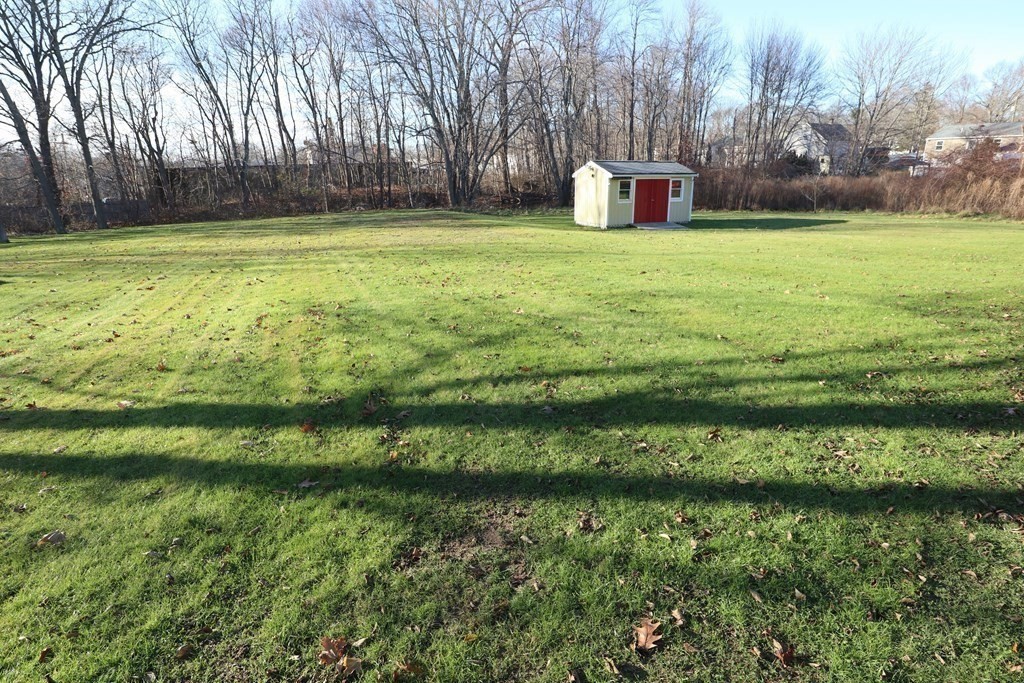 38 Pleasant Street Whitman, MA 02382 - Photo 9 of 21 a backyard of a house with lots of green space and lake view