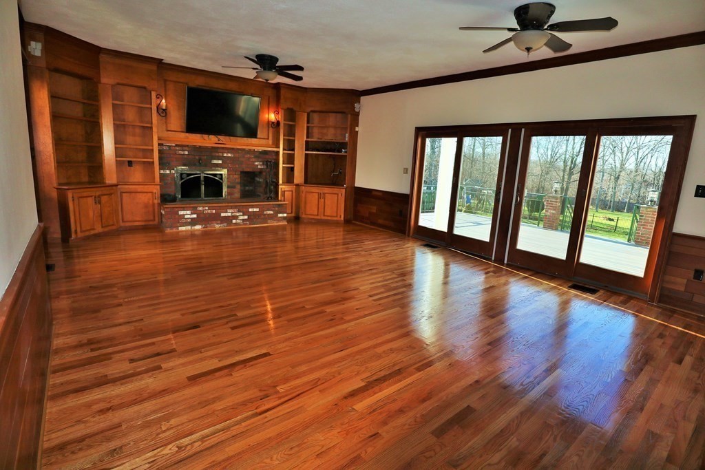38 Pleasant Street Whitman, MA 02382 - Photo 10 of 21 a living room with furniture flat screen tv and a fireplace