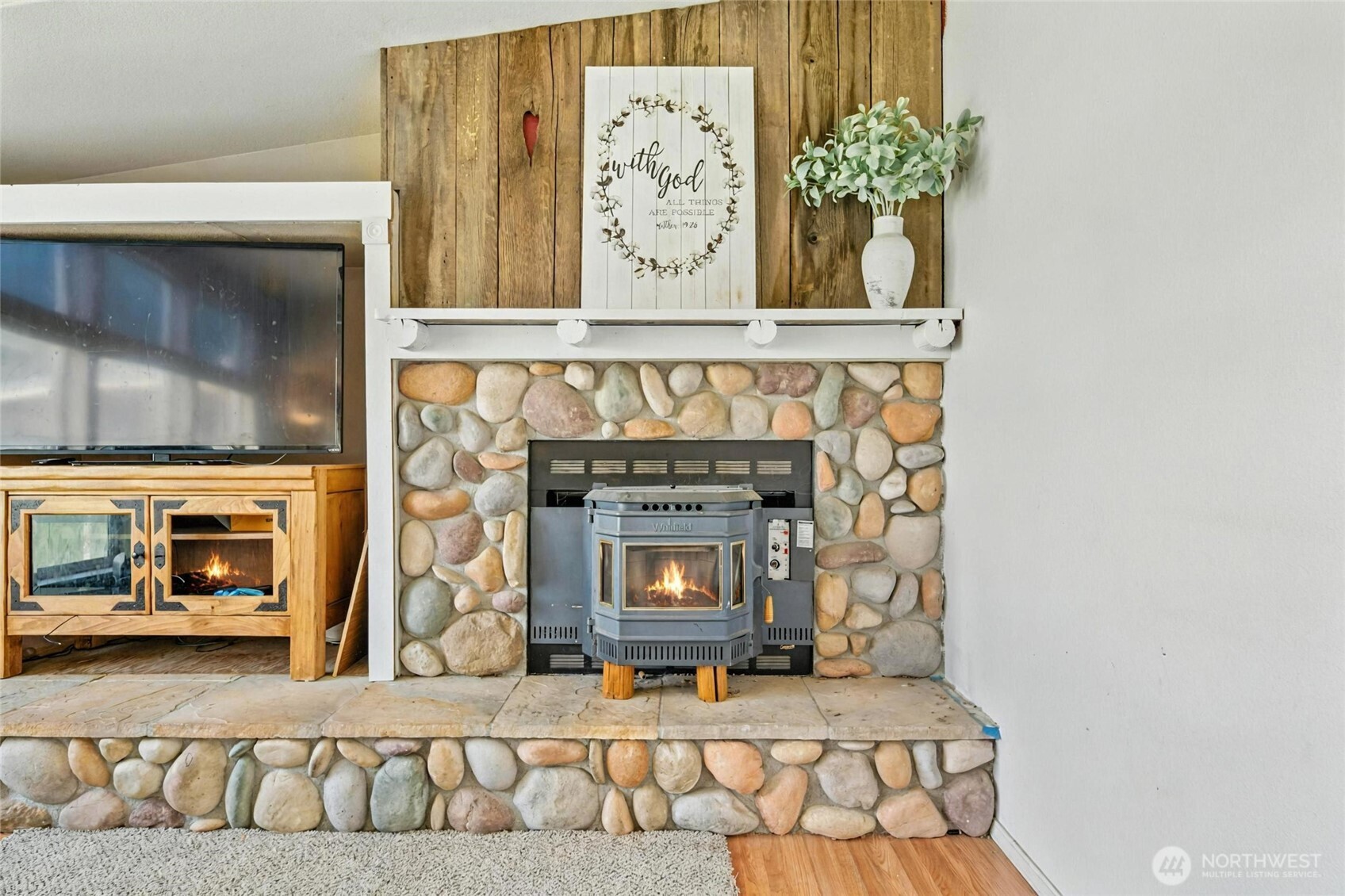 538 Burnap Road Touchet, WA 99360 - Photo 12 of 40 a living room with a fireplace and a clock