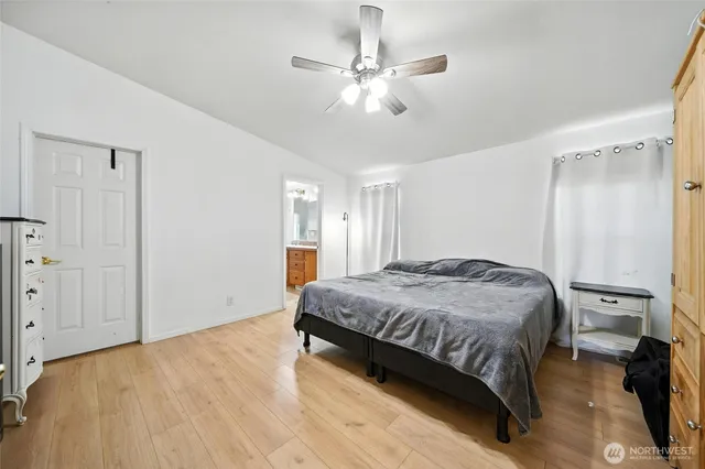 a bedroom with a bed and a chandelier