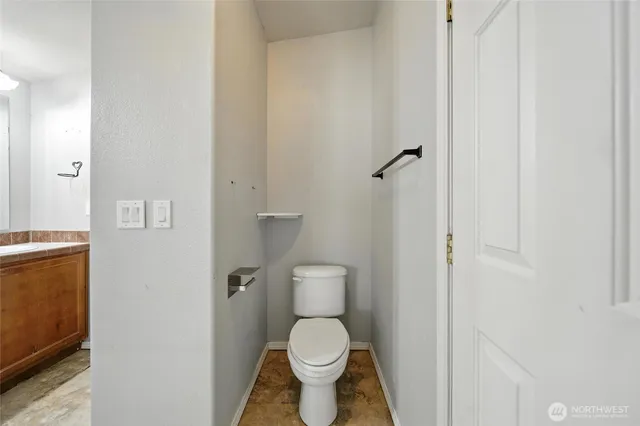 a white toilet sitting next to a white cabinet