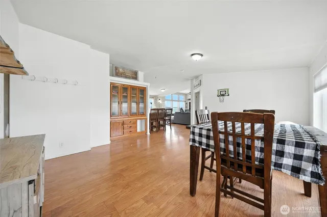 a dining room with furniture and wooden floor