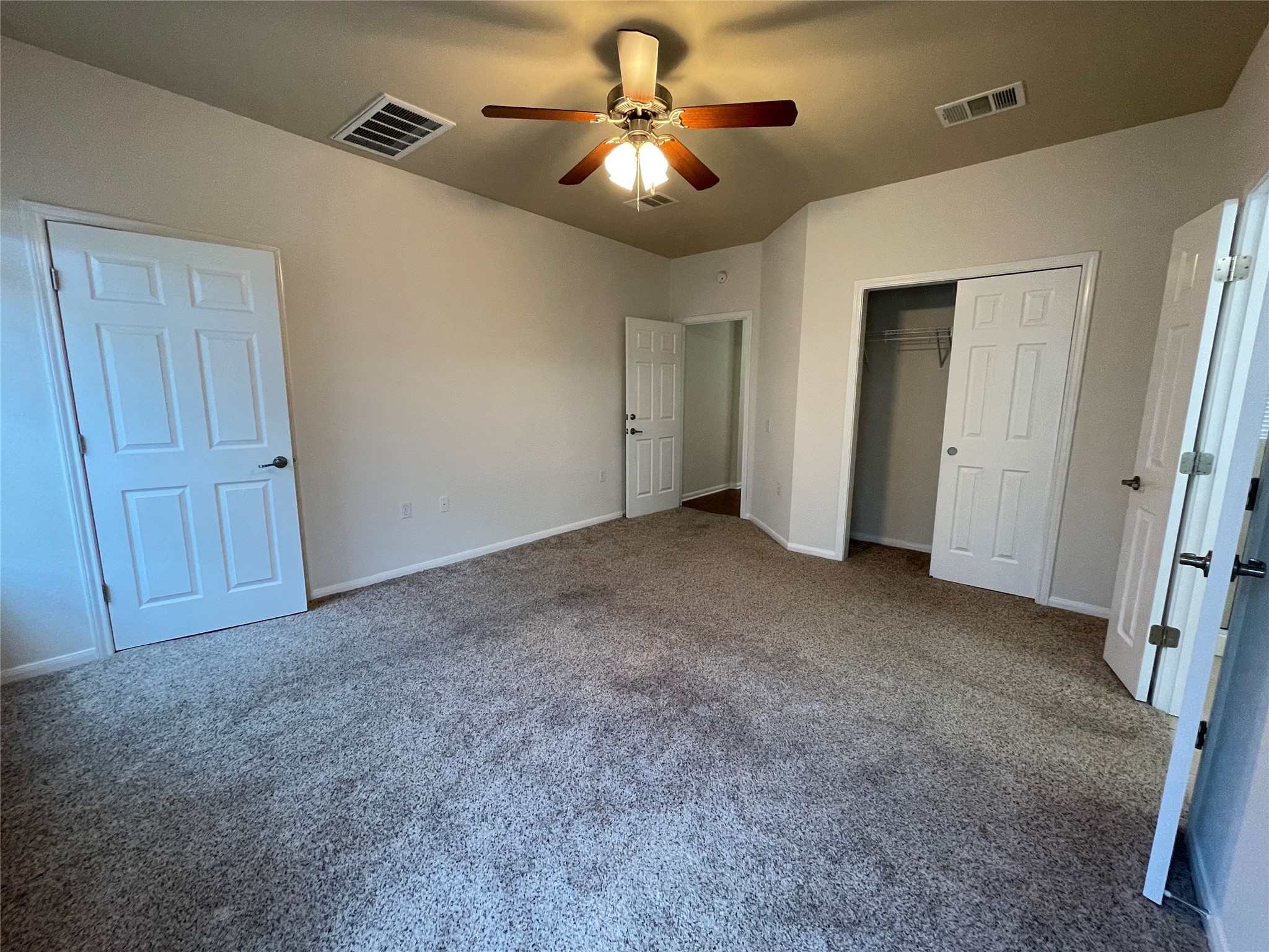 3517 Bronco Bend Loop Austin, TX 78744 - Photo 18 of 39 Unfurnished bedroom featuring a closet, a ceiling fan, and carpet