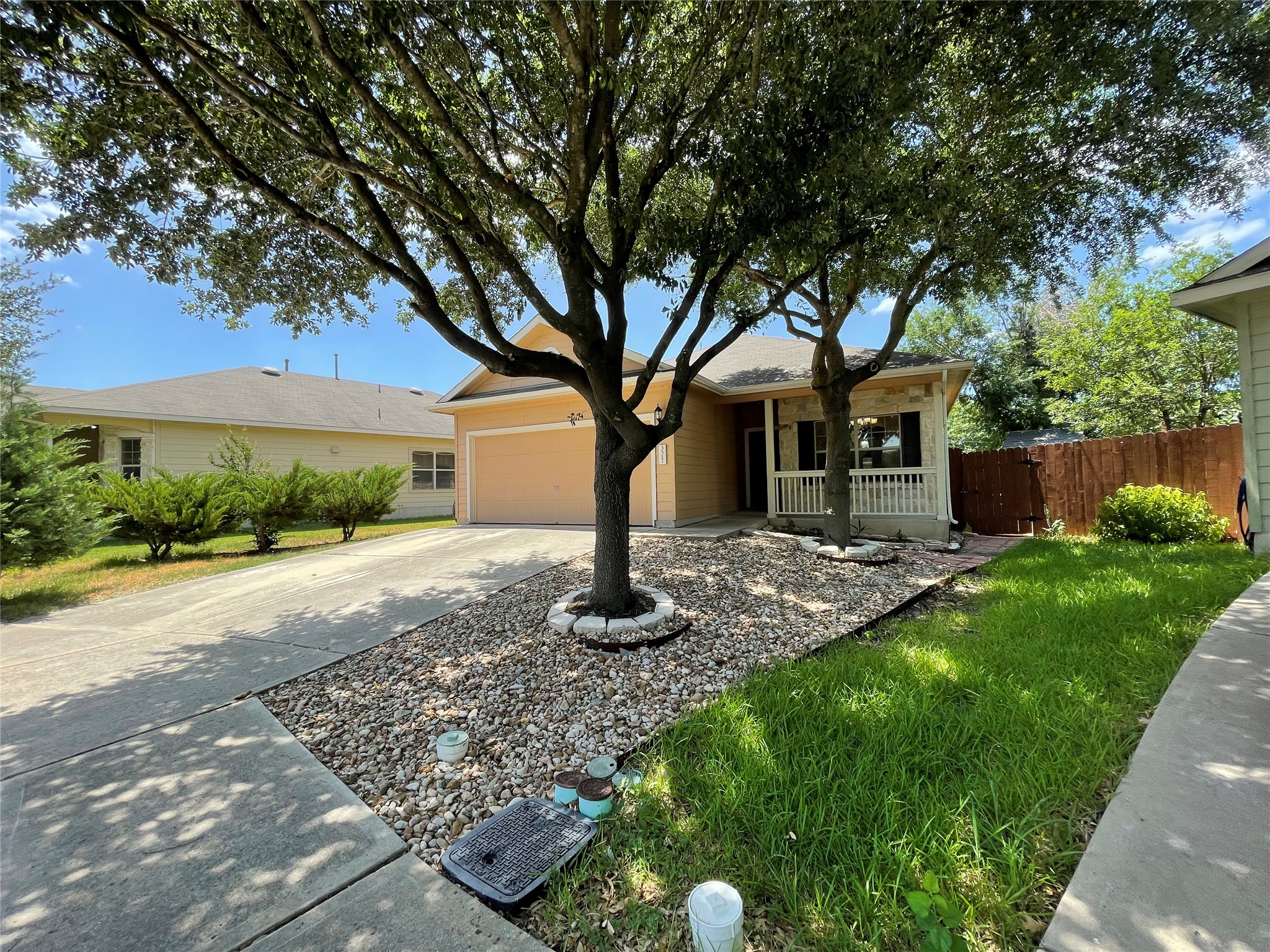 3517 Bronco Bend Loop Austin, TX 78744 - Photo 2 of 39 Single story home with concrete driveway, a garage, and a porch