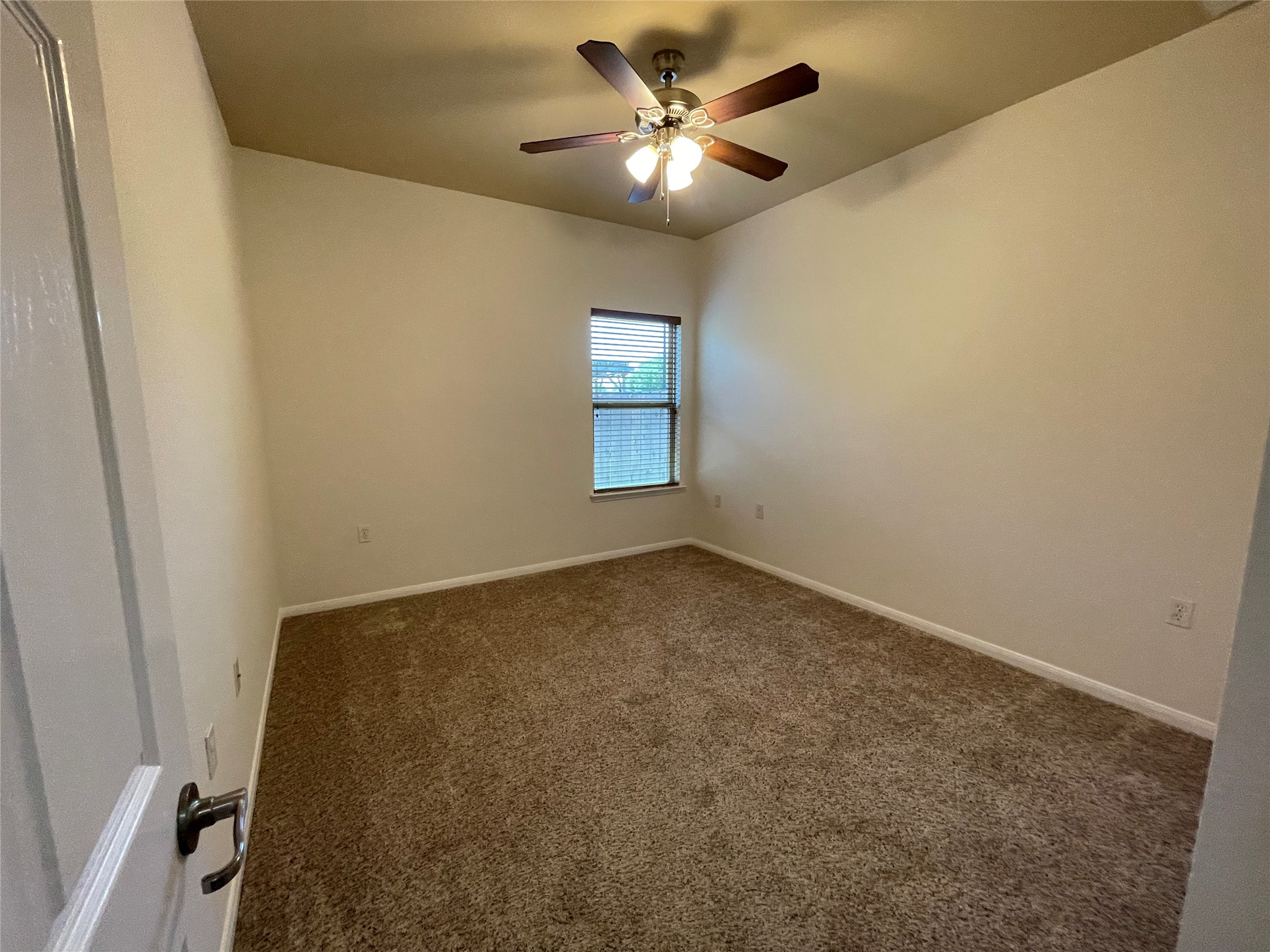 3517 Bronco Bend Loop Austin, TX 78744 - Photo 21 of 39 Spare room featuring dark carpet and ceiling fan