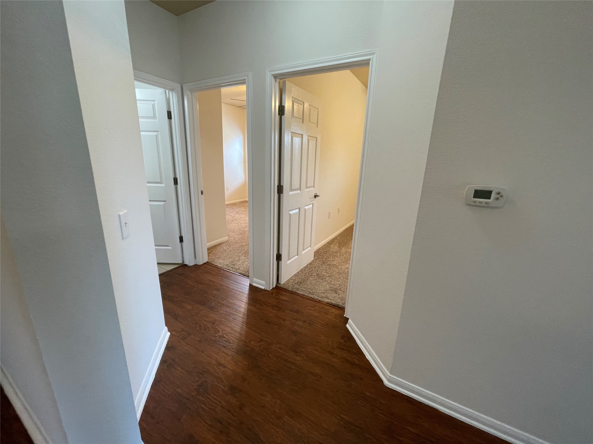 3517 Bronco Bend Loop Austin, TX 78744 - Photo 22 of 39 Corridor with baseboards and dark wood-style flooring