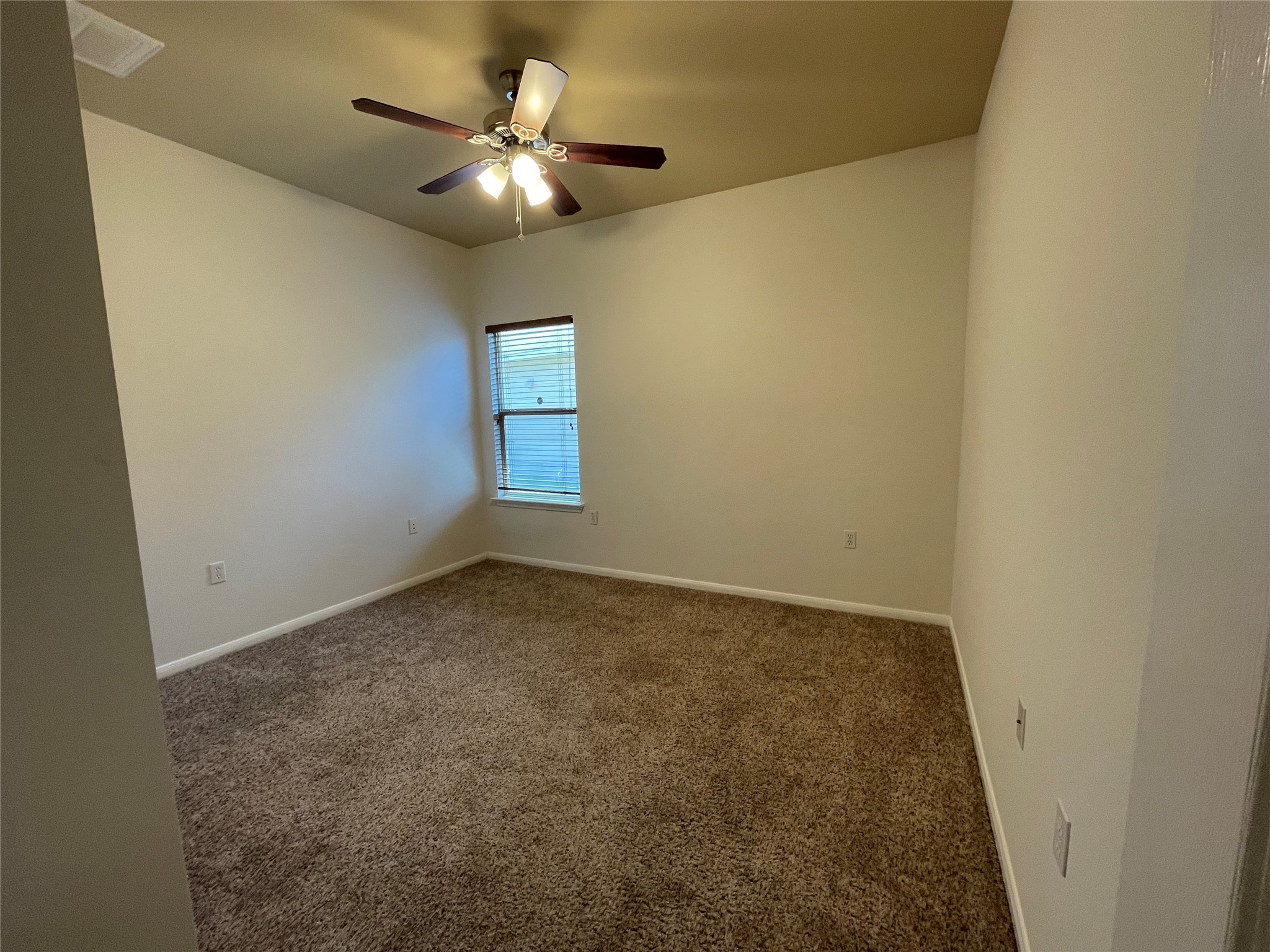 3517 Bronco Bend Loop Austin, TX 78744 - Photo 24 of 39 Spare room featuring dark colored carpet and ceiling fan
