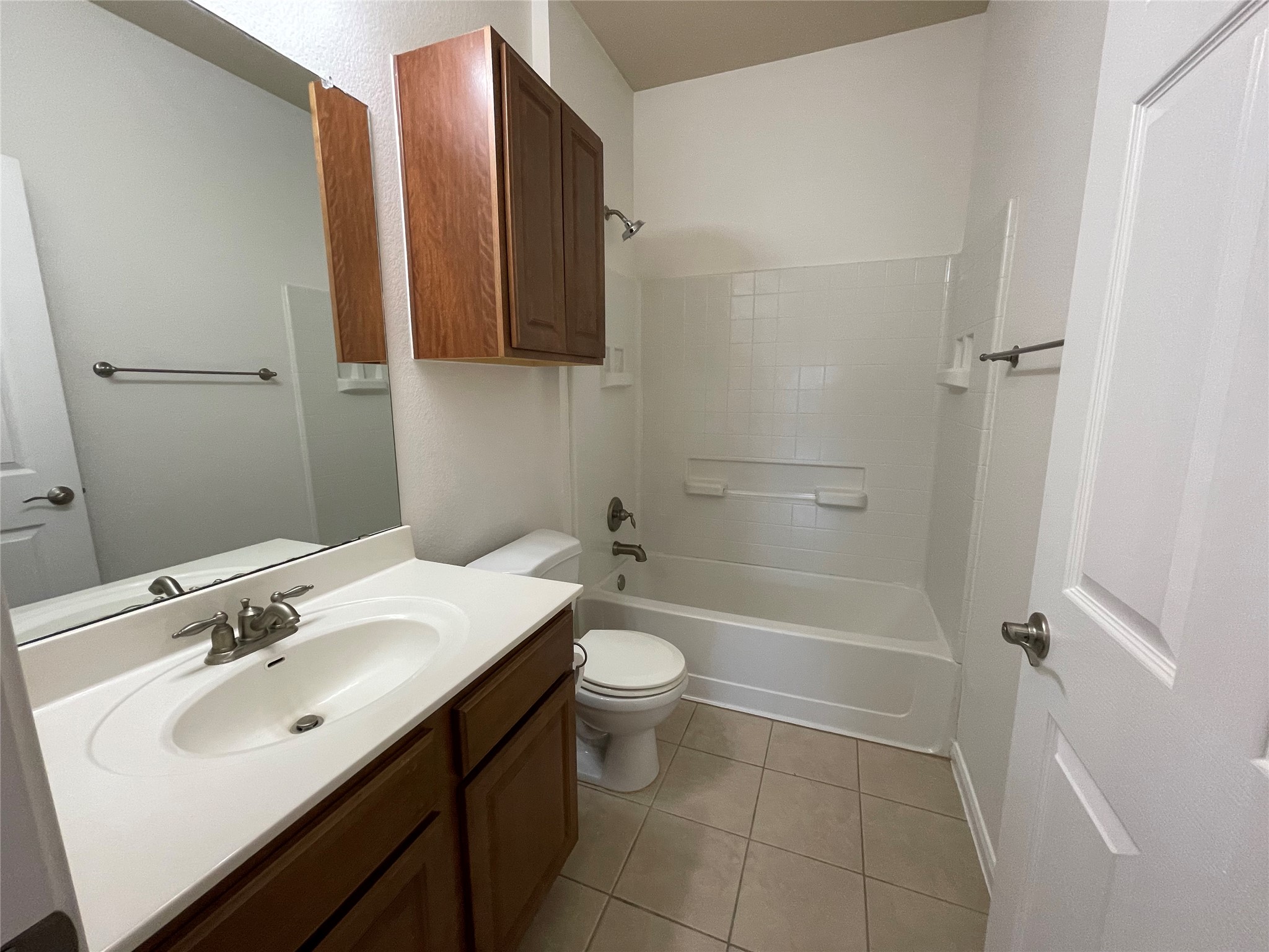 3517 Bronco Bend Loop Austin, TX 78744 - Photo 26 of 39 Bathroom featuring vanity, bathtub / shower combination, and light tile patterned floors