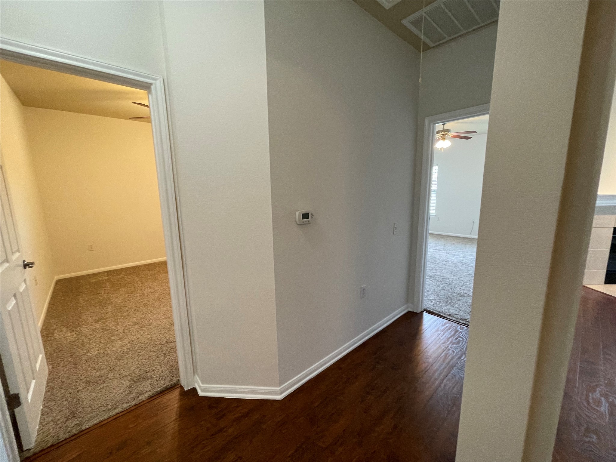3517 Bronco Bend Loop Austin, TX 78744 - Photo 28 of 39 Corridor featuring dark wood finished floors and dark carpet