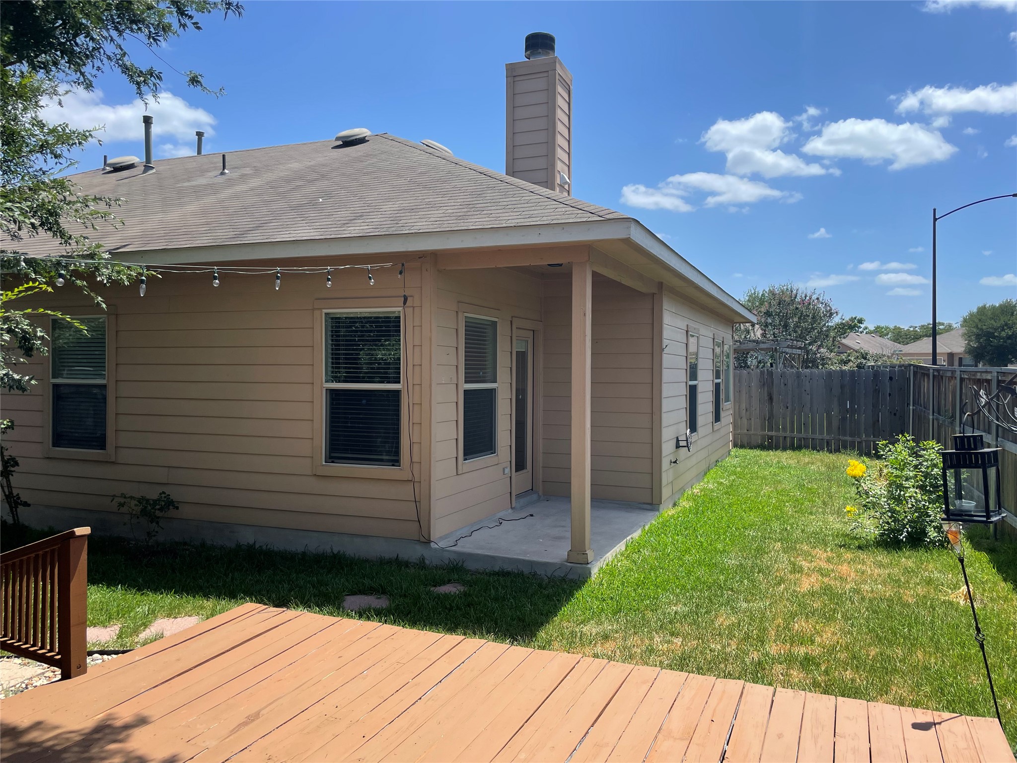 3517 Bronco Bend Loop Austin, TX 78744 - Photo 33 of 39 Back of house with a patio, a fenced backyard, a chimney, and roof with shingles